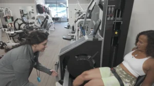 Personal trainer working with high intensity strength training client